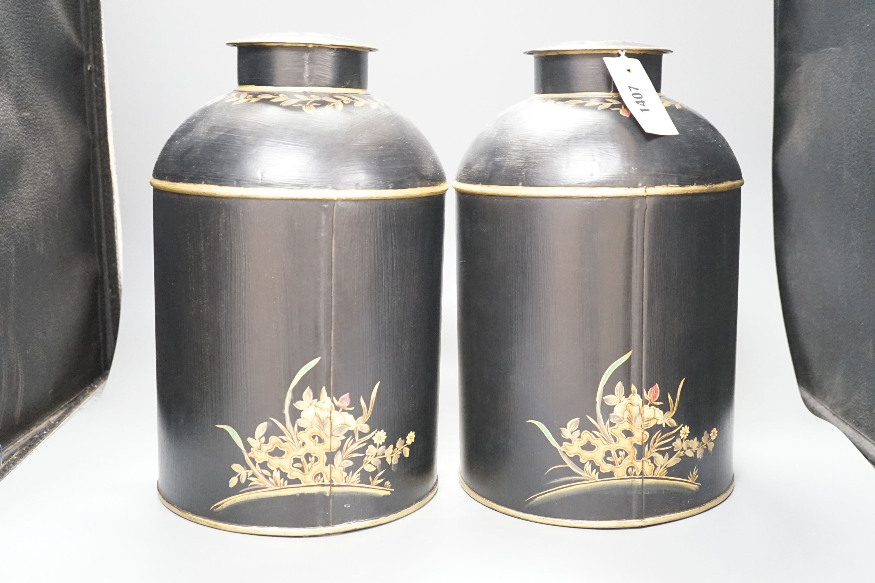 A pair of toleware style tea cannisters, 36 cms high.